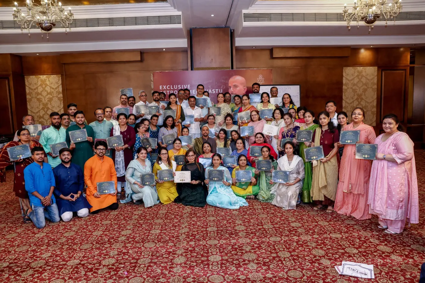 Workshop participants holding their certificates
