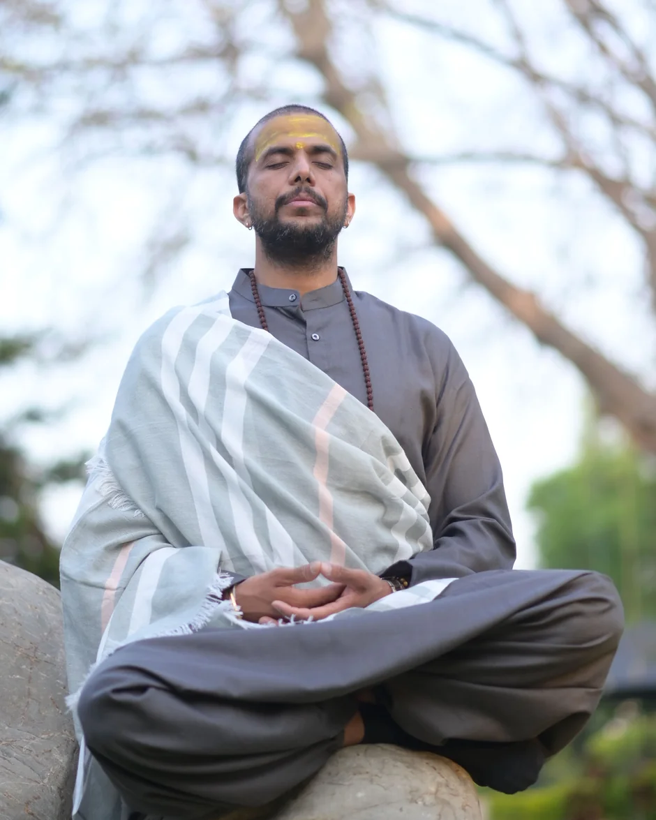 Ashishh L Vyas in seated meditation outdoors