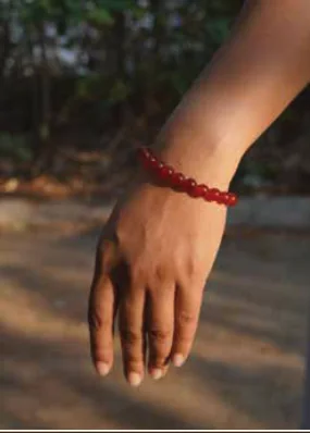 Red Bracelet worn on the wrist