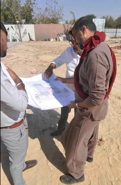 TEAM9 founder reviewing a site plan with a developer on a project site