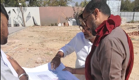 TEAM9 founder reviewing a site plan with a developer on a project site
