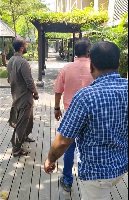 TEAM9 walking a garden pathway with clients during a site visit