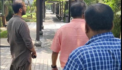 TEAM9 walking a garden pathway with clients during a site visit