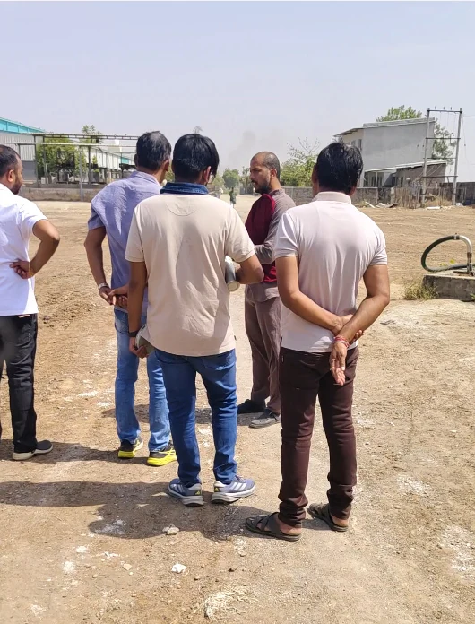 TEAM9 with clients on an open plot during a land visit